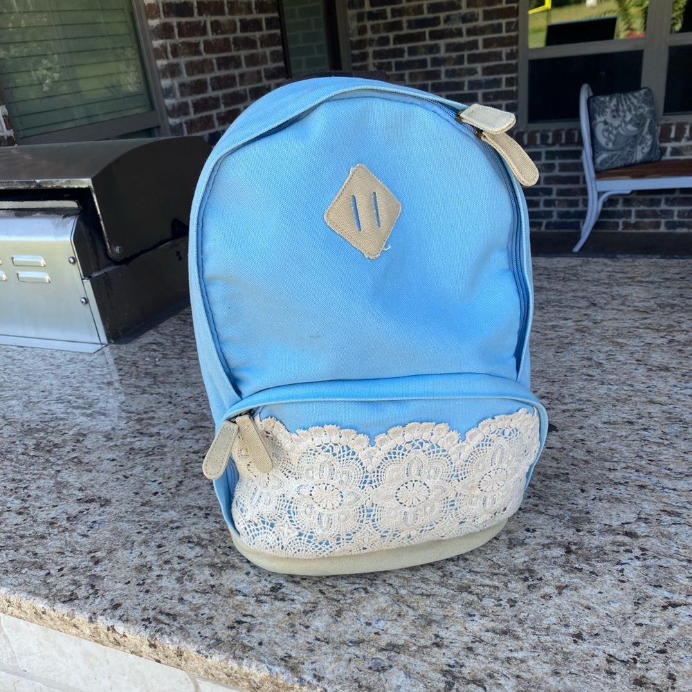 Light denim backpack with lace